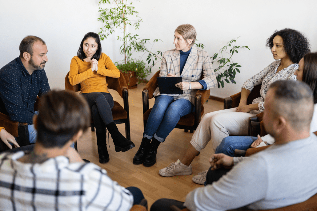 group psychotherapy, therapy group meeting with psychotherapist in a circle