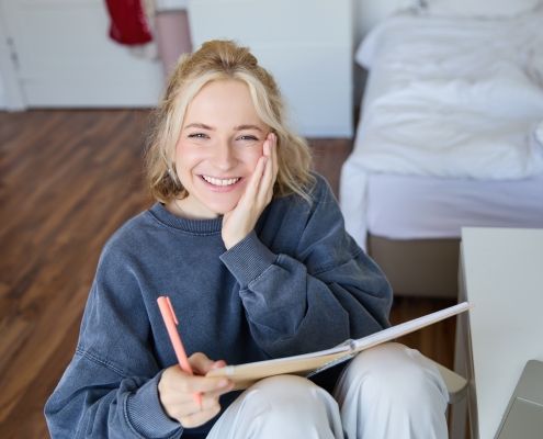 bipolar-disorder-treatment-rapid-city-sd_portrait-of-smiling-charismatic-young-woman-writing