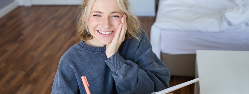 bipolar-disorder-treatment-rapid-city-sd_portrait-of-smiling-charismatic-young-woman-writing